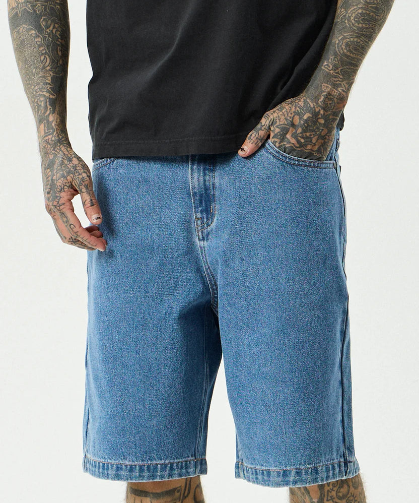 afends-lil-c-denim-baggy-short-22-inch-worn-blue1.webp