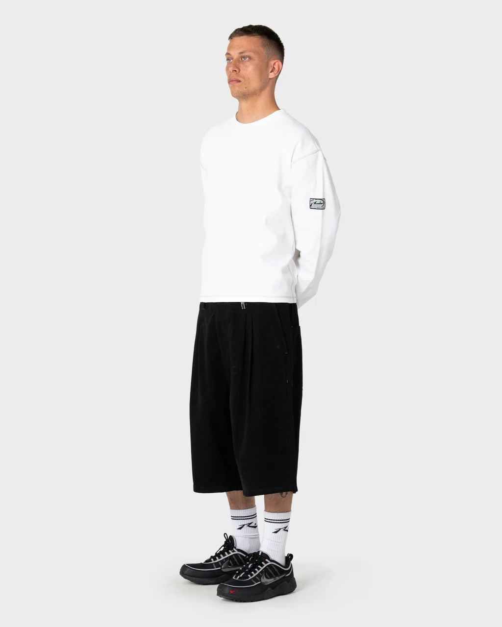 RUSTY ENIGMA PLEATED SHORT – BLACK