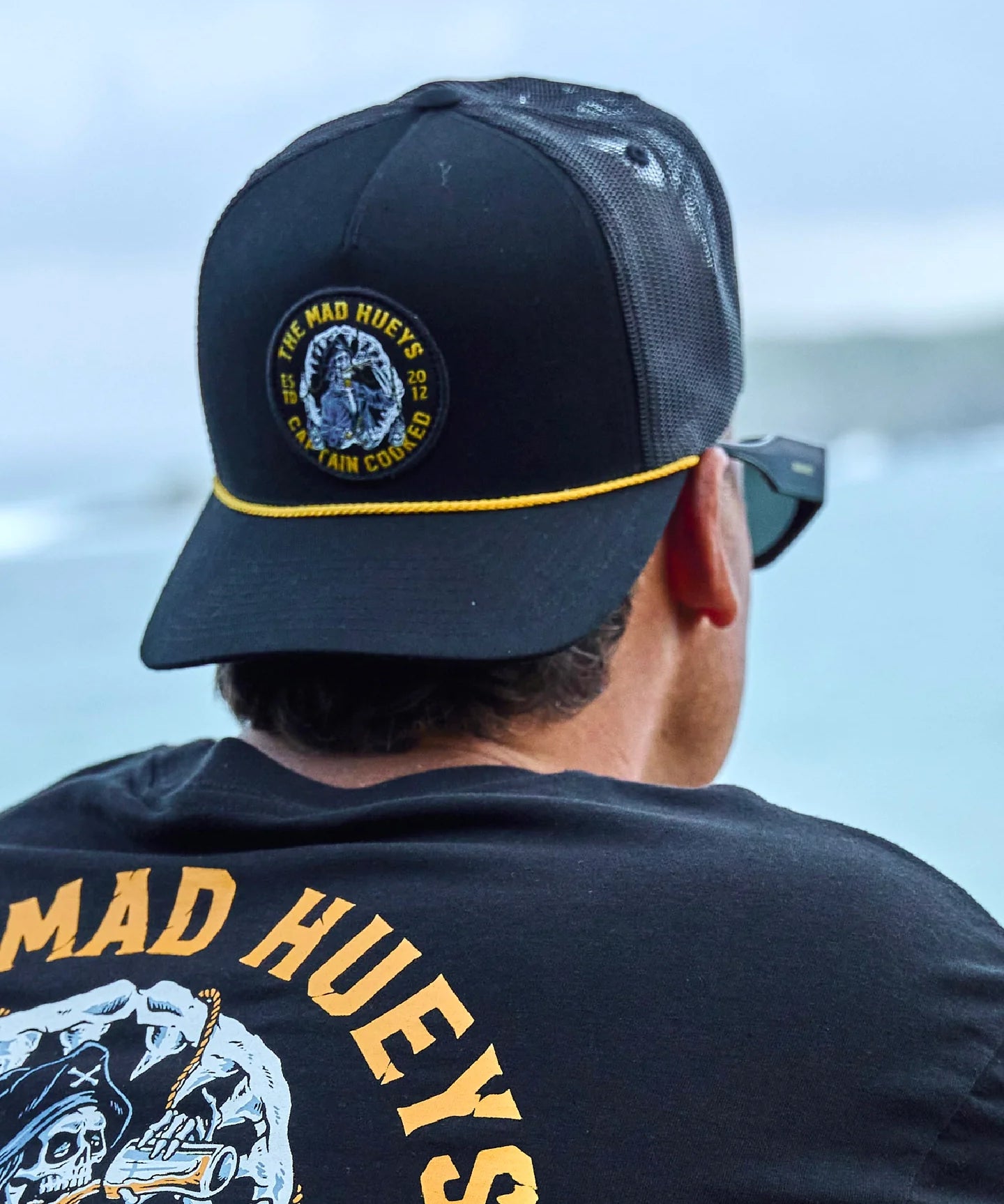 the-mad-hueys-captain-cooked-jaws-mens-trucker-cap-black-bodhi-surf.webp