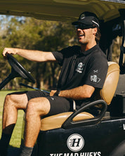 THE MAD HUEYS HITTIN FK ALL SS GOLF POLO – BLACK